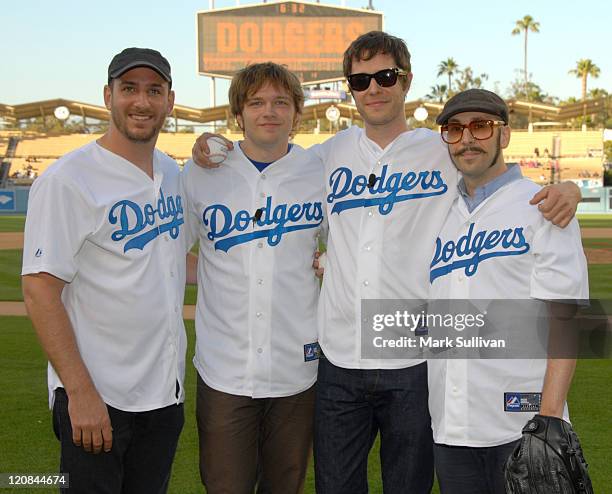 Musicians OK Go Dan Konopka, Andy Ross, Damian Kulash and Tim Nordwind pose before throwing the ceremonial first pitch prior to the game between the...