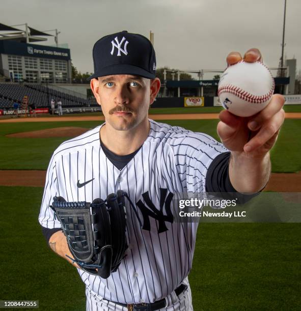 New York Yankees left-handed pitcher James Paxton holds up a baseball during spring training in Tampa, Florida on Feb. 20, 2020.