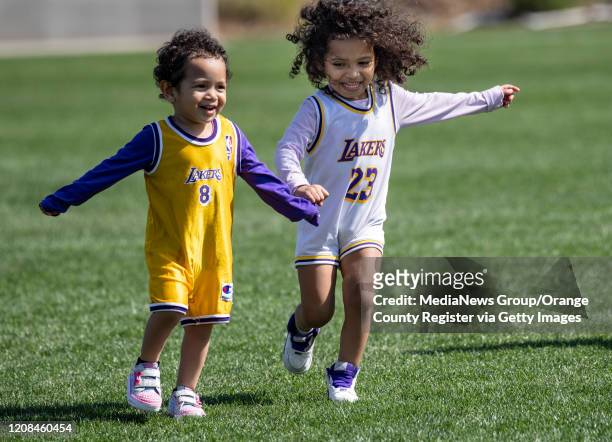 Sisters Maisha Bell left, and Makena are dressed in honor of Kobe Bryant during a memorial service broadcast for the former Laker at The Great Park...
