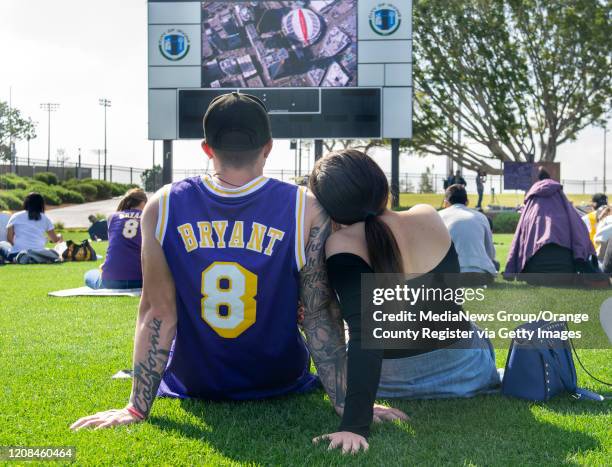 Adrian and Mercedes Villa watch the broadcast of Kobe Bryant"u2019s memorial services at The Great Park in Irvine, CA on Monday, February 24, 2020....