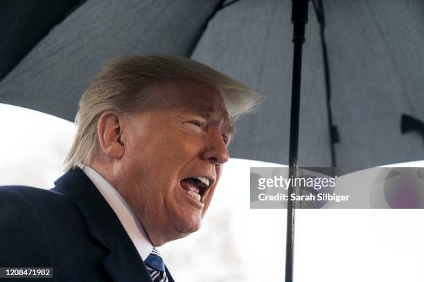 President Donald Trump speaks to a press gaggle as he departs for the Naval Station Norfolk in Norfolk, Virginia, from the White House on March 28,...