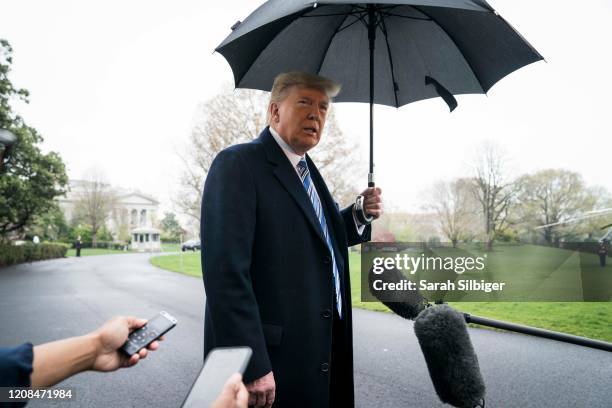 President Donald Trump speaks to a press gaggle as he departs for the Naval Station Norfolk in Norfolk, Virginia, from the White House on March 28,...