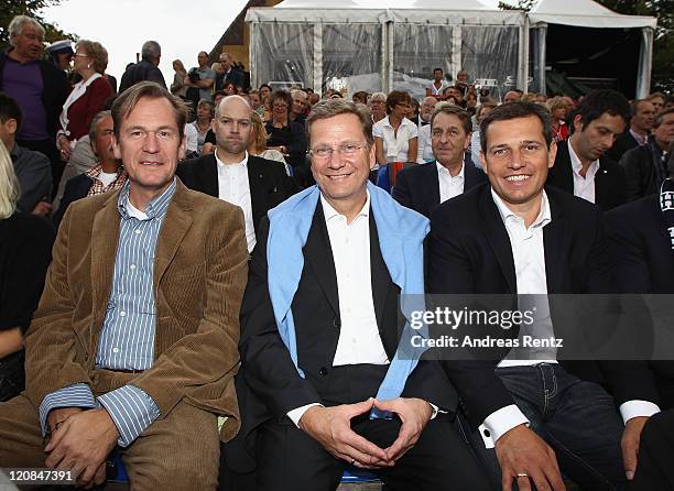 Mathias Doepfner, Guido Westerwelle and partner Michael Mronz attend the 'The Magic Flute' premiere by Wolfgang Amadeus Mozart during the...