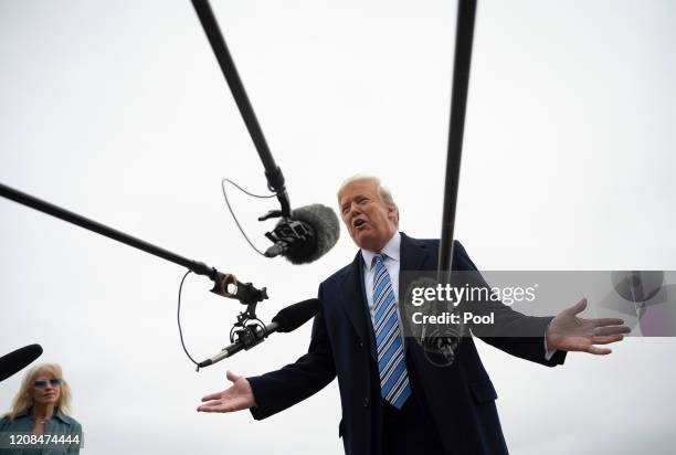 President Donald Trump speaks to the press as White House Senior Advisor Kellyanne Conway looks on before boarding Air Force One on March 28, 2020 at...