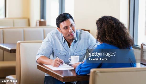 business people meeting in restaurant over coffee - face to face interview stock pictures, royalty-free photos & images