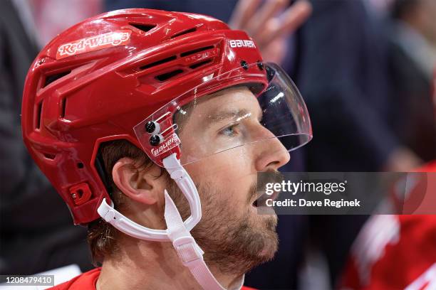 Darren Helm of the Detroit Red Wings watches the action from the bench against the Calgary Flames during an NHL game at Little Caesars Arena on...