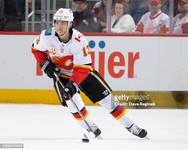 Johnny Gaudreau of the Calgary Flames skates up ice with the puck against the Detroit Red Wings during an NHL game at Little Caesars Arena on...