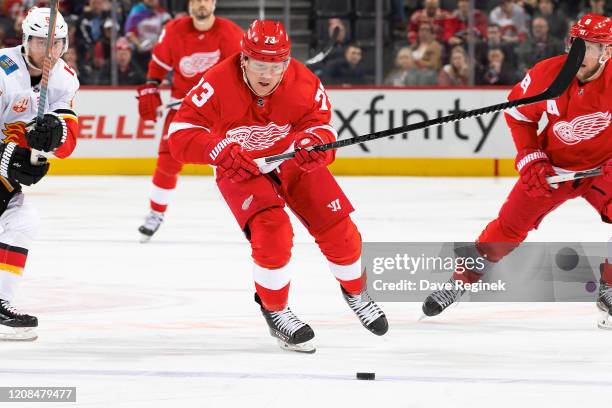 Adam Erne of the Detroit Red Wings skates after a loose puck against the Calgary Flames during an NHL game at Little Caesars Arena on February 23,...