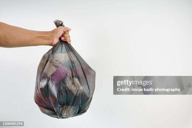 holding plastic bag with copy space - plastic bag stock pictures, royalty-free photos & images