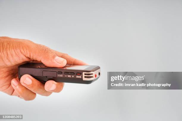 holding voice recorder - dictaphone stock pictures, royalty-free photos & images