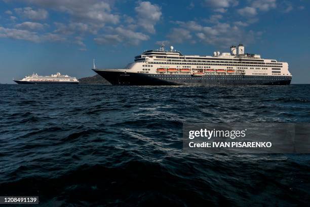 Holland America's cruise ship Zaandam and the Rotterdam cruise ship are seen in Panama City bay on March 28, 2020. - Earlier Saturday, Panama's...