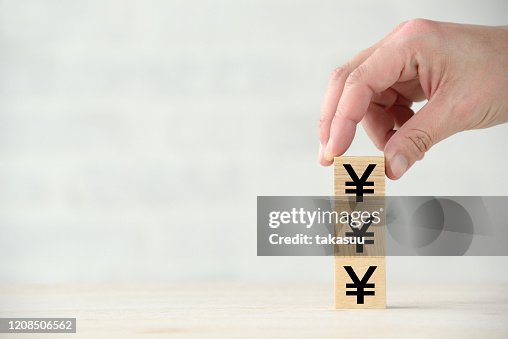 Increasing Japanese yen images with wooden blocks Increasing Japanese yen images with wooden blocks