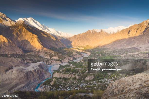 natural view along karakorum mountains at hunza valley with cherry blossom autumn season pakistan - islamabad stock pictures, royalty-free photos & images