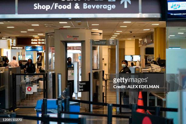 Worker with a face mask is seen at Ronald Reagan Washington National Airport on March 29 in Arlington, Virginia. - The coronavirus death toll shot...