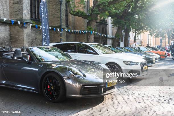 porsche 911 carrera s cabriolet 992 sports car and audi rs6 avant performance station wagon - porsche 911 stock pictures, royalty-free photos & images