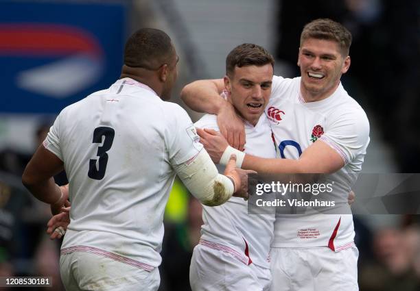 George Ford of England celebrates with Owen Farrell and Kyle Sinckler after scoring England's first try during the 2020 Guinness Six Nations match...