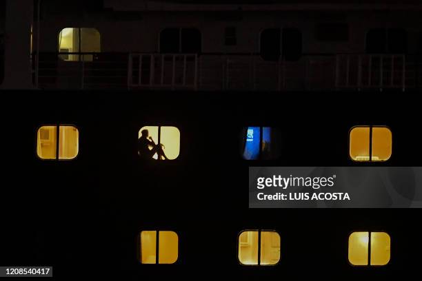 Passangers of Holland America's cruise ship Zaandam are seen as the ship navigates through the Panama Canal in Panama City, on March 29, 2020....