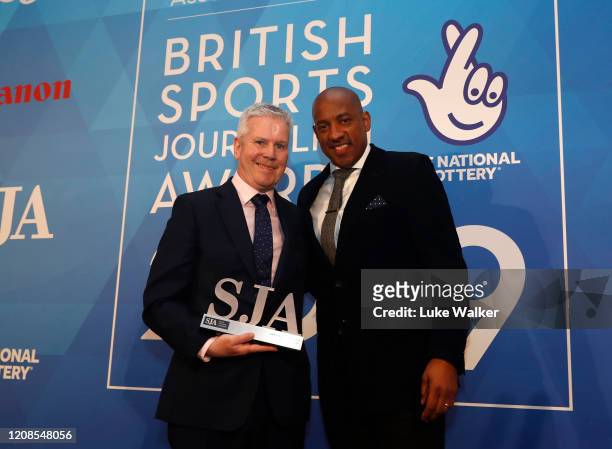 Mike Costello, BBC radio 5 live receives the Sports commentator award from Dion Dublin during the SJA British Sports Journalism Awards 2019 at Park...