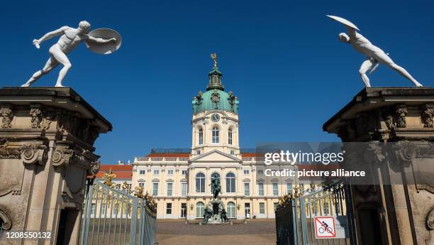 March 2020, Berlin: Charlottenburg Palace with the rice statue of Elector Friedrich Wilhelm, and guard figures at the entrance gate. Photo: Jens...