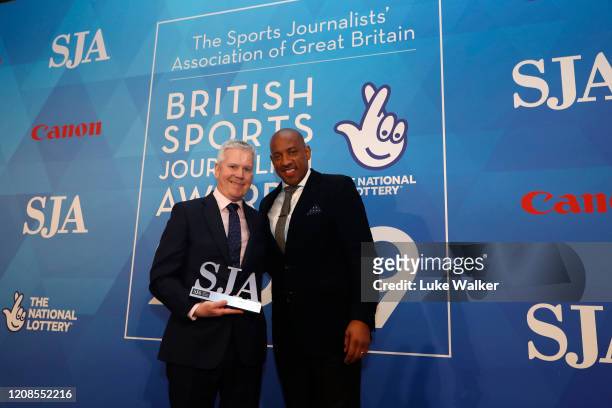 Mike Costello, BBC radio 5 live receives the Sports commentator award from Dion Dublin during the SJA British Sports Journalism Awards 2019 at Park...