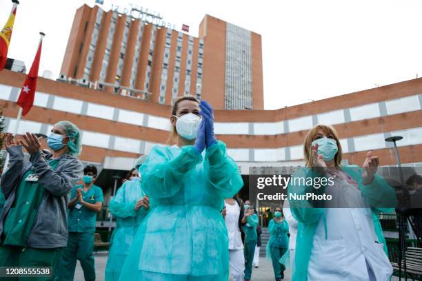 Sanitation workers from 12 de Octubre Hospital applaud Spanish police and Madrid's Fire Department as a symbol of gratitud for their support during...