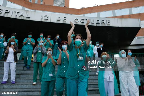 Sanitation workers from 12 de Octubre Hospital applaud Spanish police and Madrid's Fire Department as a symbol of gratitud for their support during...