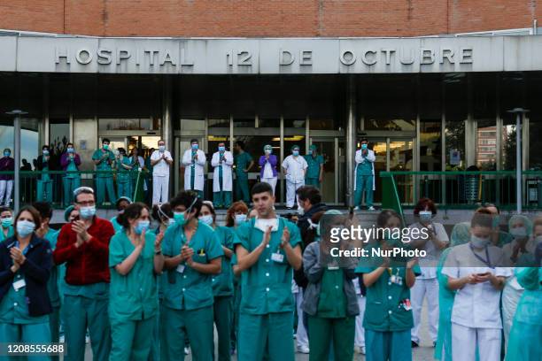 Sanitation workers from 12 de Octubre Hospital applaud Spanish police and Madrid's Fire Department as a symbol of gratitud for their support during...