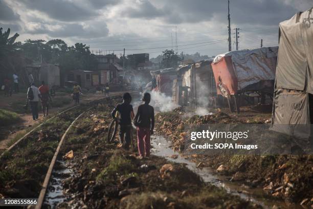 Children play along the train tracks in Namuwongo slum during the coronavirus outbreak. So far only 33 people have been confirmed to be infected with...