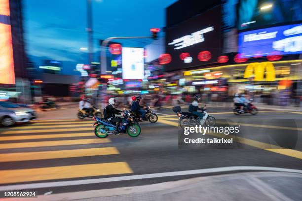 motorcycles crossing malls at the bukit bintang, kuala lumpur, malaysia - kuala lumpur road stock pictures, royalty-free photos & images