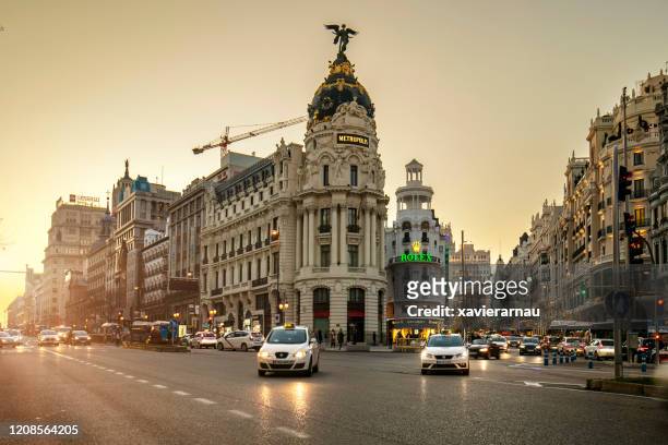 gran via in madrid at sunset - madrid stock pictures, royalty-free photos & images