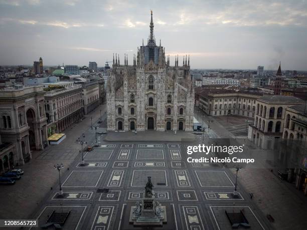 General view shows almost deserted piazza del Duomo where is Duomo di Milano . The Italian government imposed unprecedented restrictions to halt the...