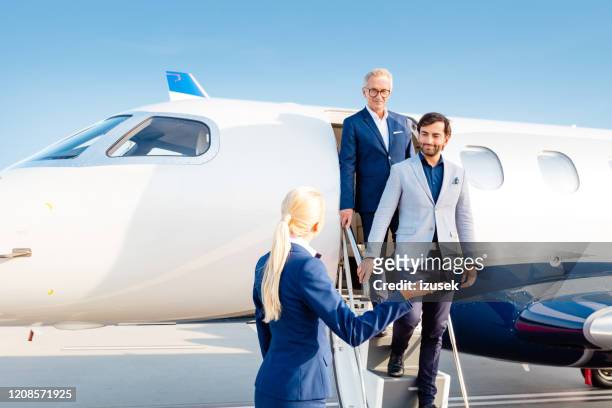 business people arriving by private jet at the airport - celebrities stock pictures, royalty-free photos & images