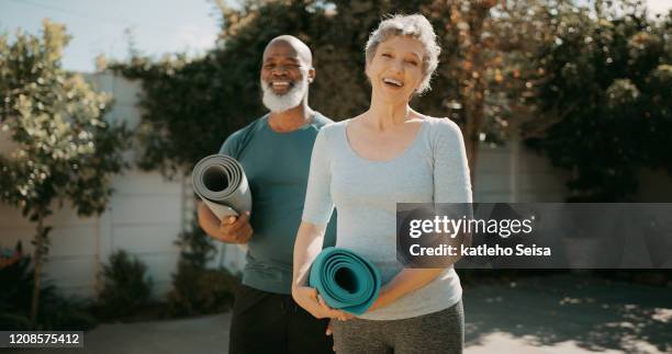 couples who yoga together stick together - senior yoga stock pictures, royalty-free photos & images