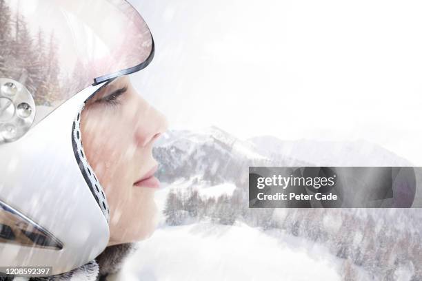 woman in ski helmet looking out at view - gesicht kälte stock-fotos und bilder