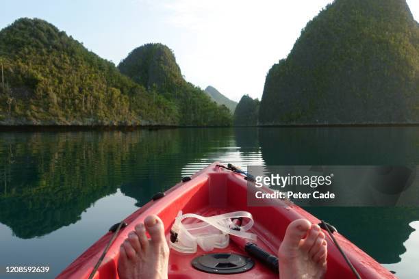 person kayaking near tropical island - raja ampat islands bildbanksfoton och bilder