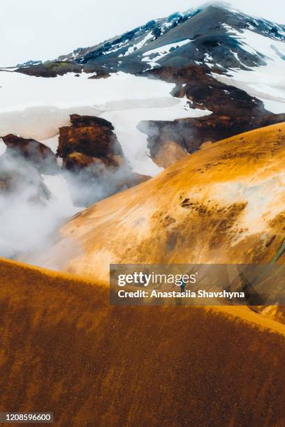 silhouette of woman hiking at the scenic dramatic volcanic landscape in iceland - smokey mountain spring stock pictures, royalty-free photos & images