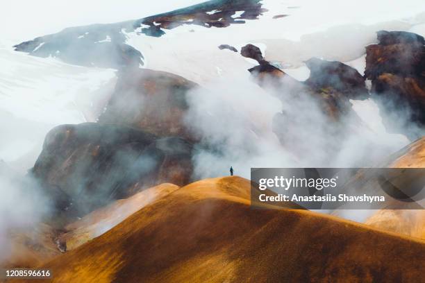 silhouette of woman hiking at the scenic dramatic volcanic landscape in iceland - smokey mountain spring stock pictures, royalty-free photos & images