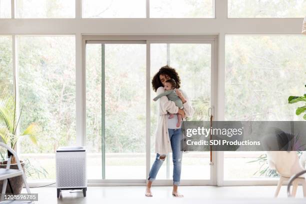 young mom comforts baby boy - sliding door imagens e fotografias de stock