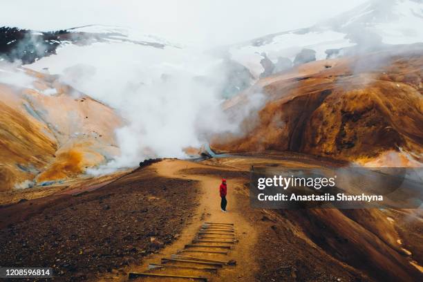 man hiking at the scenic dramatic volcanic landscape in iceland - iceland mountains stock pictures, royalty-free photos & images