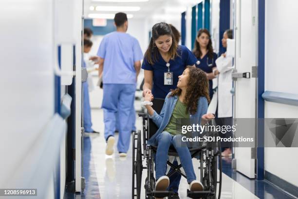 preteen patient talks with nurse - nurse huddle stock pictures, royalty-free photos & images