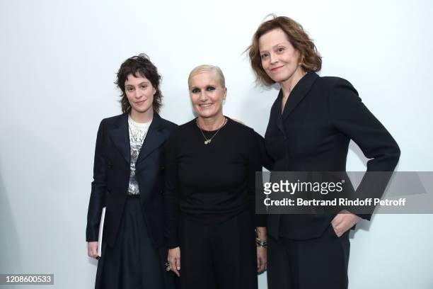 Stylist Maria Grazia Chiuri standing between Sigourney Weaver and her daughter Charlotte Simpson pose after the Dior show as part of the Paris...