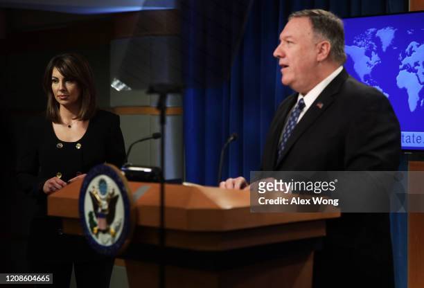 Secretary of State Mike Pompeo speaks as State Department spokesperson Morgan Ortagus listens during a news briefing at the State Department February...