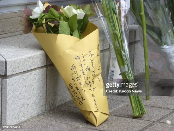 Flowers are placed on March 30 in front of the home of veteran Japanese comedian Ken Shimura, who died of pneumonia caused by the novel coronavirus...