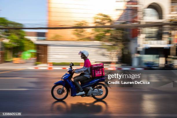 Motorbike food delivery drivers on March 30, 2020 in Bangkok, Thailand. Due to the spread of Covid-19, Bangkok called for an immediate closure of all...
