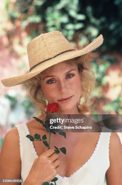 Portrait of American model and actress Lauren Hutton, a rose in one hand, on the set of her film, 'Zorro, the Gay Blade' , 1980.