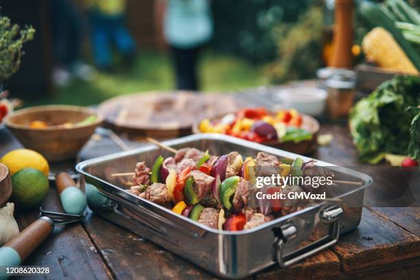 preparing lamb kebab outside in the garden - skewer stock pictures, royalty-free photos & images