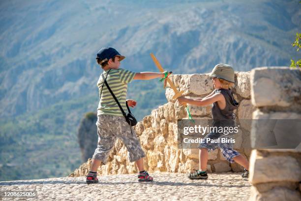 little boys playing knight, guadelest, andalusia, spain - ritter spielzeug stock-fotos und bilder