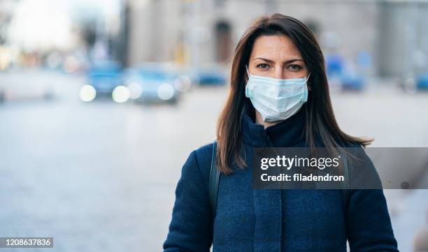 woman with face protective mask - covid 19 mask stock pictures, royalty-free photos & images