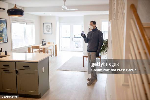 Tom Landry, broker and owner of Benchmark Real Estate, does a Facebook Live tour of a condo for sale in the East End of Portland on Monday, March 23,...