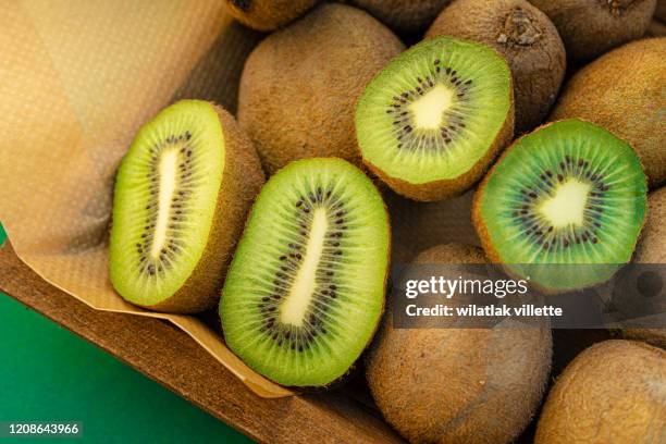 kiwi fruit slices on  background - kiwi fruit stock pictures, royalty-free photos & images